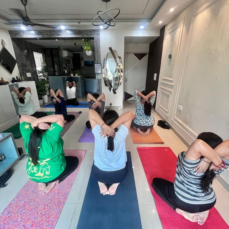 Students in Uttan Mandookasana pose in class